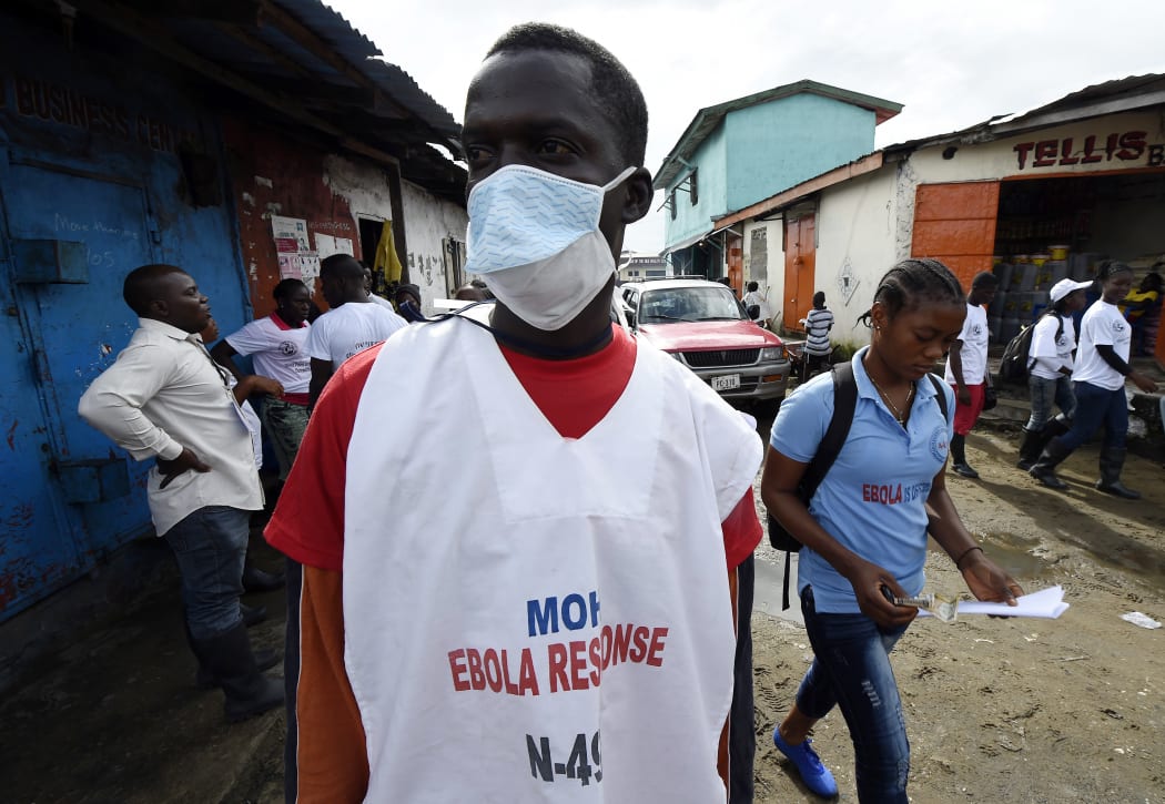 A Liberian health ministry employee visits the West Point district in Monrovia as part of an awareness campaign for Ebola.