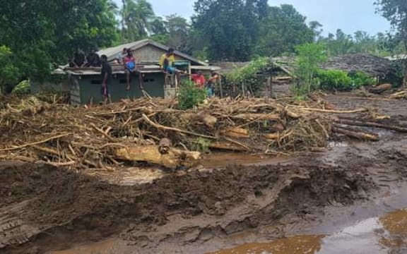 Residents in Vanuatu's capital Port Vila look on the damages caused by Cyclone Judy.