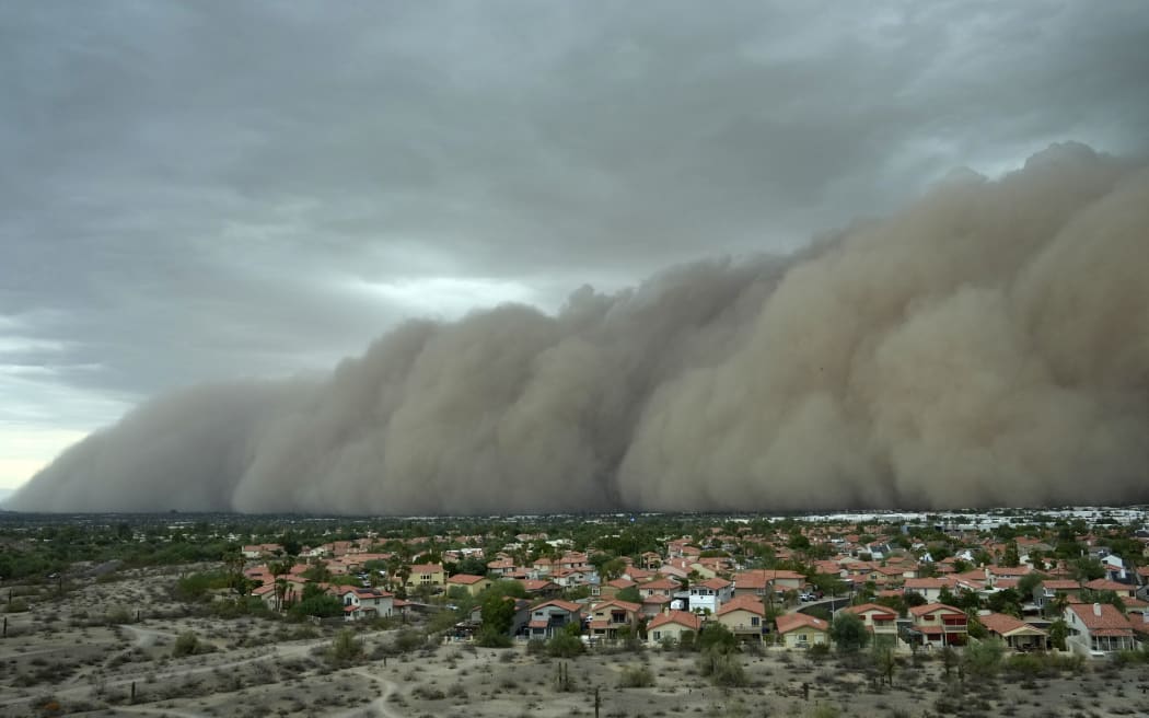 A giant dust storm approaches the Phoenix metro area as a monsoon storm pushes the dust into the air Monday.