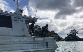 Leading Hydrographic Systems Technician Ryan Hulse (left) supervises Able Chef Dominique Telfar-Valks as she conducts a sound velocity profile.