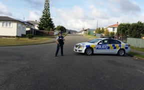 Police continue to stand guard in the area on the second day of the stand-off.