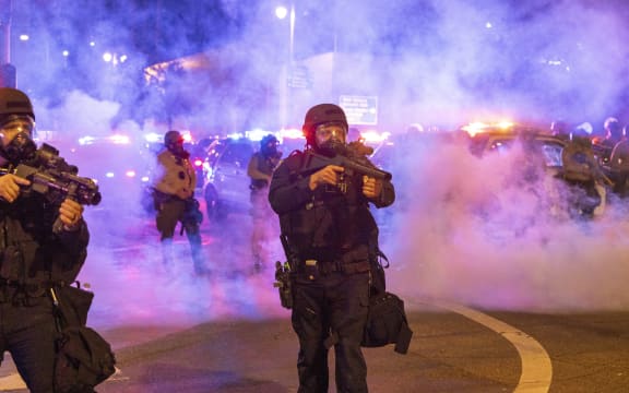 Law enforcement take positions on the streets surrounding the federal building during a protest following federal immigration operations in Los Angeles, California, on June 8, 2025. Demonstrators torched cars and scuffled with security forces in Los Angeles on June 8, as police kept protestors away from the National Guard troops President Donald Trump sent to the streets of the second biggest US city. (Photo by RINGO CHIU / AFP)