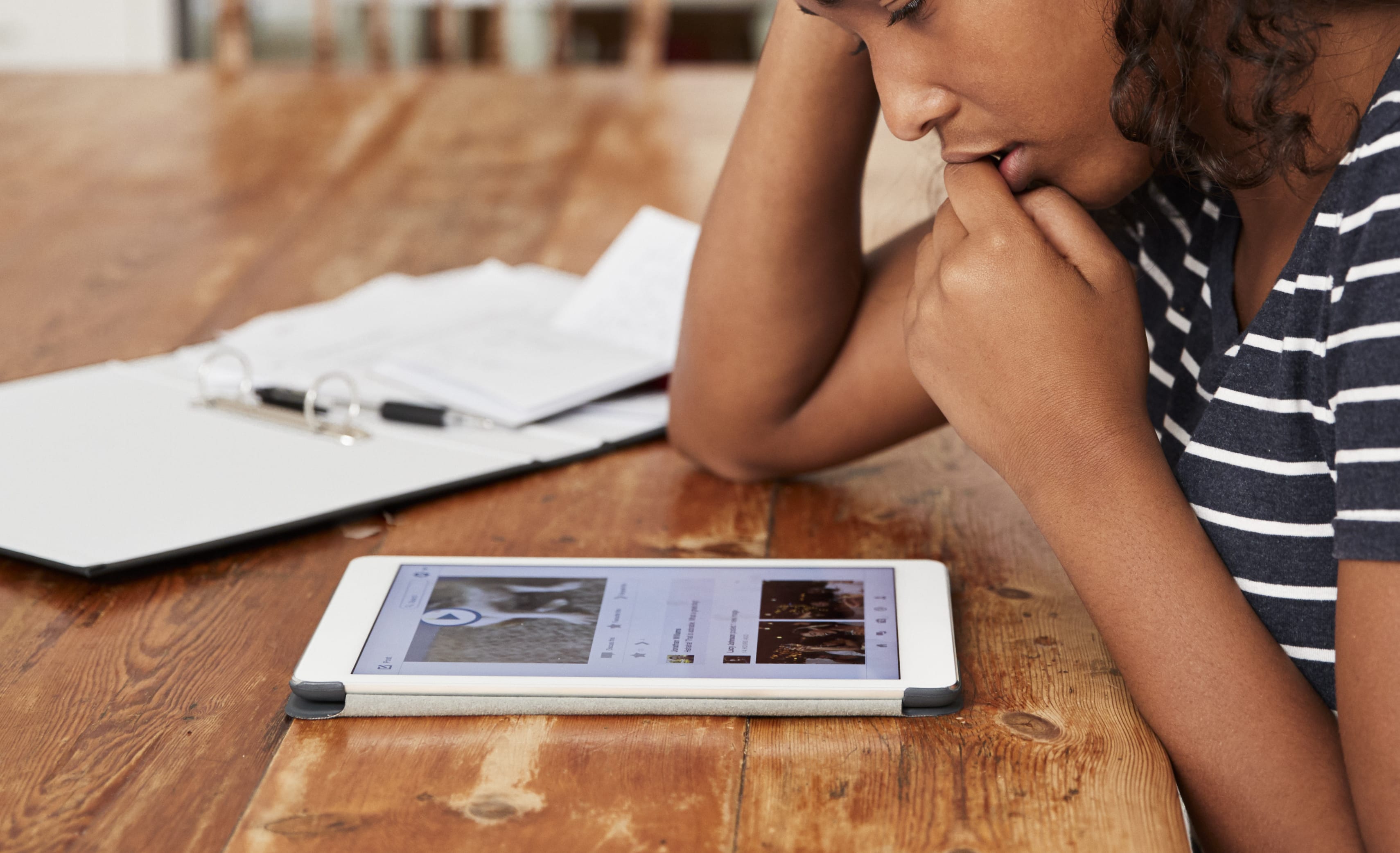 Teenage Girl At Home Using Digital Tablet Being Bullied On Line
