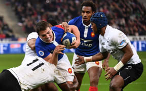 France halfback Antoine Dupont is stopped by Fiji wing Vereniki Goneva.