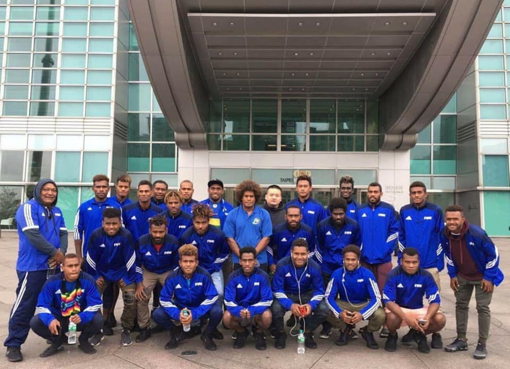 Solomon Islands pose outside the National Stadium in Taipei before their victory.