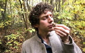 Merlin Sheldrake smelling a white truffle (tuber magnatum) in a wood in Italy