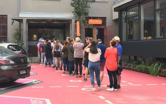 A queue forms for an open home viewing at Leeds Street apartments in Wellington.