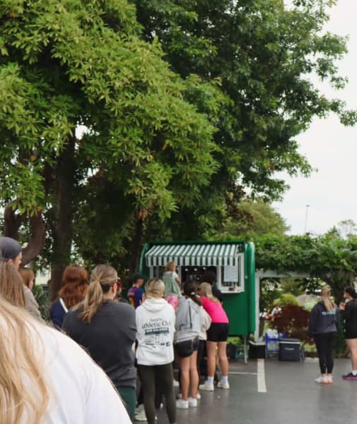 A line of thirsty patrons snake from @Gigi's matcha van in The Vale, Christchurch.