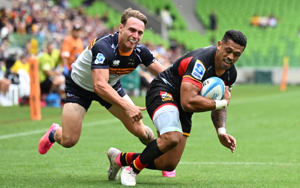 Etene Nanai-Seturo scores while being tackled by Corey Toole  during the Super Rugby Pacific Round two match between the Chiefs and the Brumbies at AAMI Park in Melbourne.