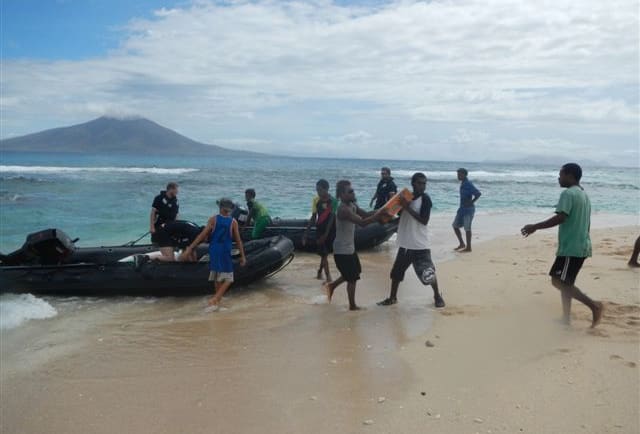 The Marine Survey Team taking Zodiacs ashore with military and USAR reps, then following up with food and water.