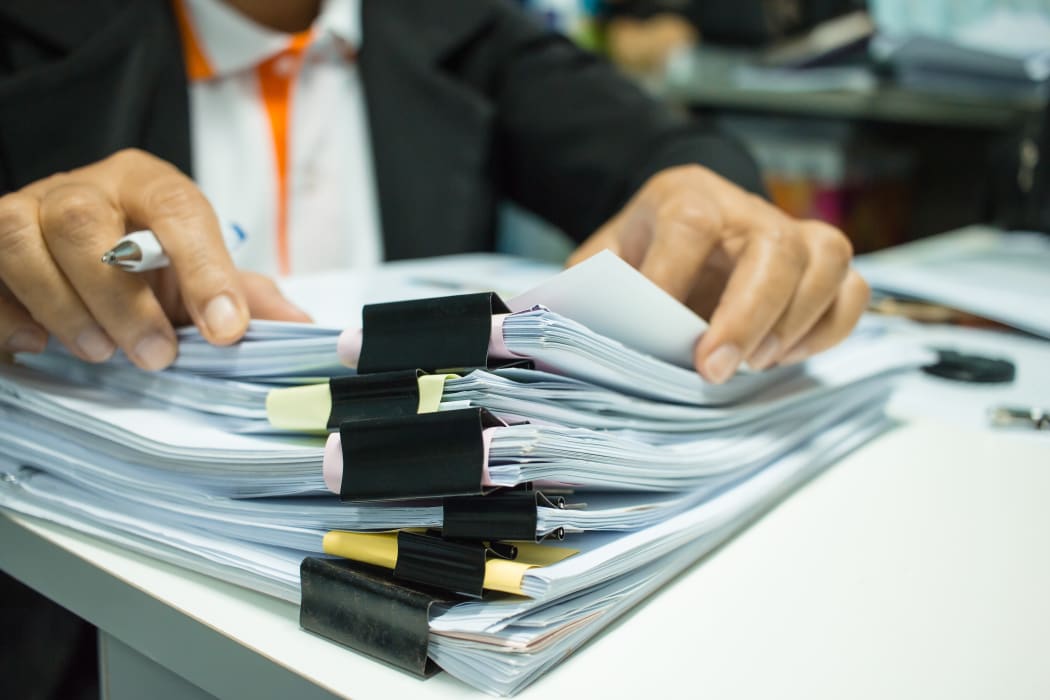 Stacks of documents in an office.