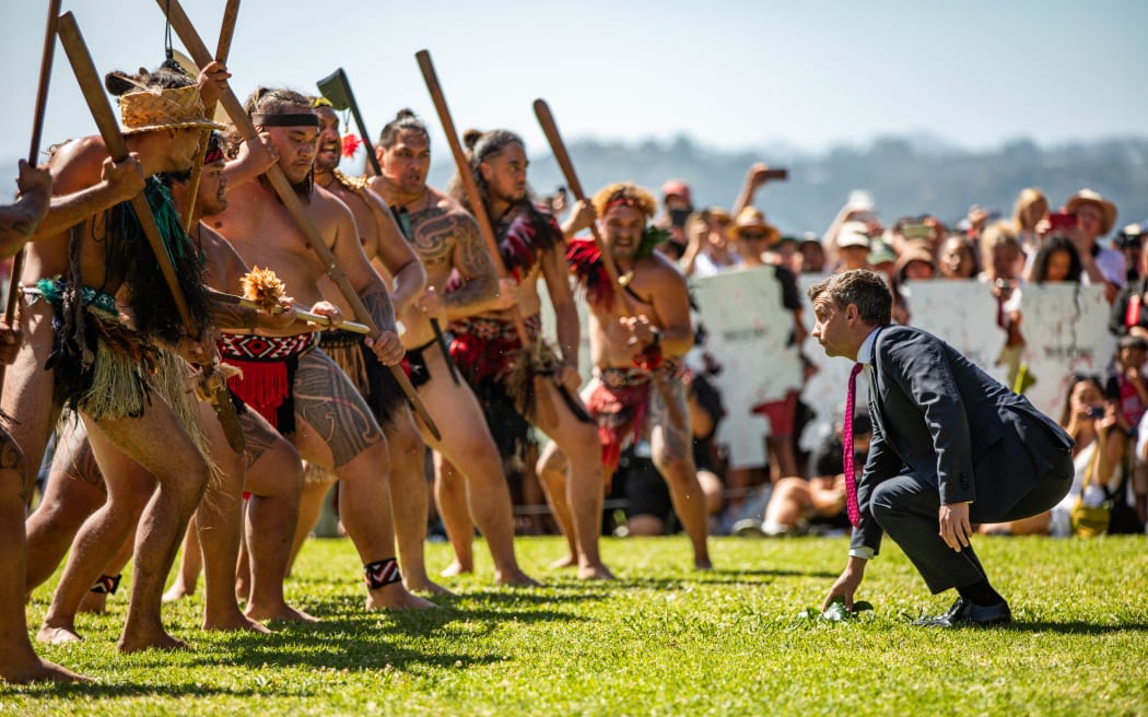 David Seymour accepts the wero (challenge) from several waiwero (warriors) at the Waitangi Treaty Grounds 5 February 2024