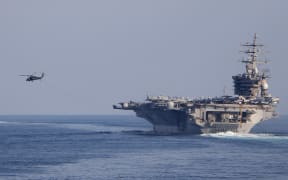 In this photo obtained from the US Department of Defense, the US Navy's aircraft carrier USS Dwight D. Eisenhower (CVN 69) (IKE) transits the Strait of Hormuz on November 26, 2023. The United States said on November 29 that an Iranian drone flew dangerously close to the USS Dwight D. Eisenhower aircraft carrier the day before. The Eisenhower is the centerpiece of one of two carrier strike groups deployed as part of US efforts to deter Iran and its proxy forces in the Middle East from escalating the Israel-Hamas war into a broader regional conflict. (Photo by Ruskin Naval / US Department of Defense / AFP) / RESTRICTED TO EDITORIAL USE - MANDATORY CREDIT "AFP PHOTO / US Department of Defense/US Navy" - NO MARKETING NO ADVERTISING CAMPAIGNS - DISTRIBUTED AS A SERVICE TO CLIENTS