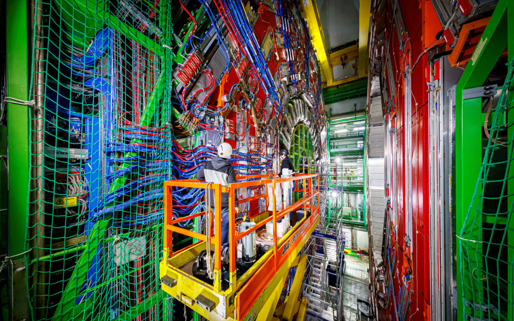 Engineers work on the Compact Muon Solenoid (CMS) detector assembly in a tunnel of the Large Hadron Collider (LHC) at the European Organisation for Nuclear Research (CERN), during maintenance works on February 6, 2020 in Cessy, France, near Geneva. Six years after the historic discovery of the Higgs boson, the world's largest particle accelerator is taking a break to boost its power, hoping to find new particles that would explain, among other things, dark matter, one of the great enigmas of the Universe.