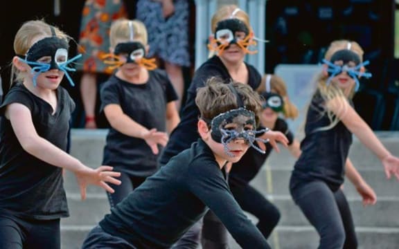 Members of the Ohope Beach School Choir performing the Evil Weasel Gang dance