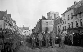 New Zealand troops marching through Le Quesnoy on 10 November 1918.