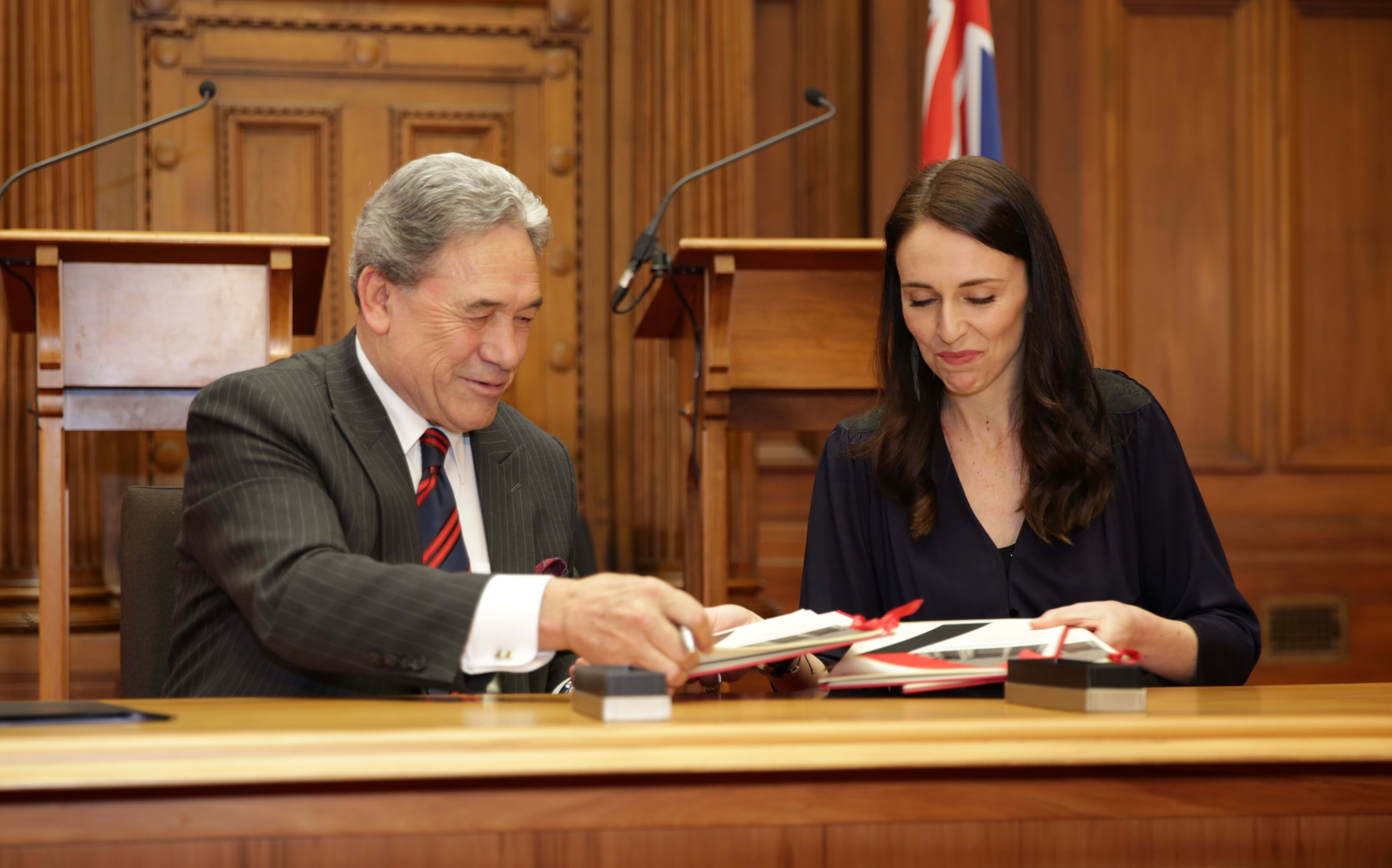 Jacinda Ardern and Winston Peters signing the coalition agreement.