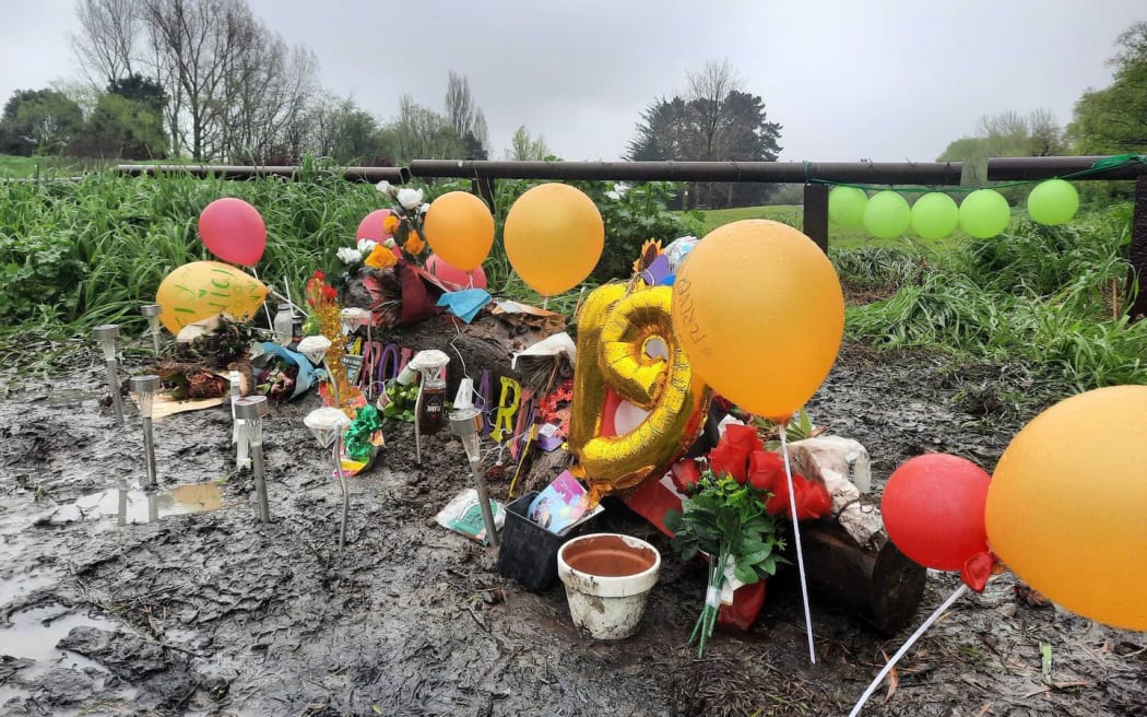 Balloons and flowers left at the site Ariki Rigby's body was found.