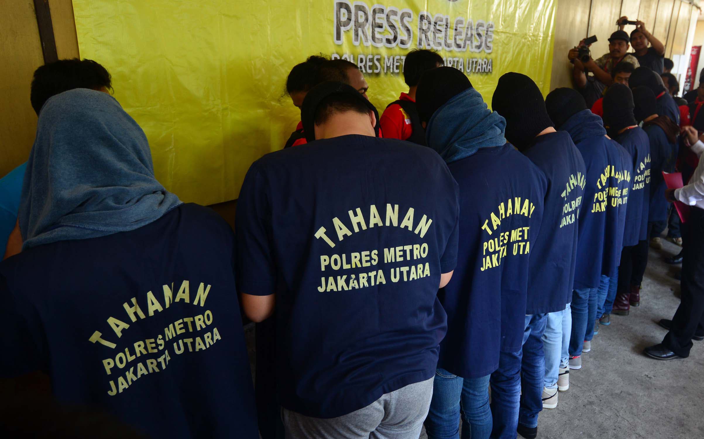 Men arrested in a recent raid stand in line during a news  conference at a police station in Jakarta on 22 May.