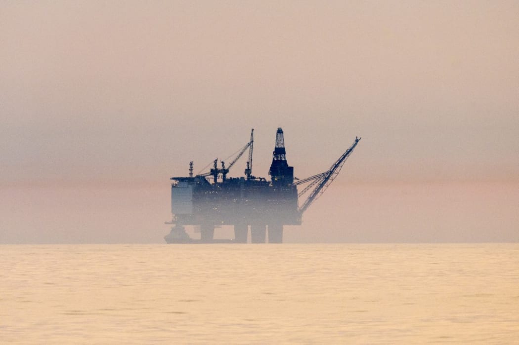 Oil platform at sunset in the North Sea off the coast of Scotland (Photo by Raphael Sane / Biosphoto / Biosphoto via AFP)