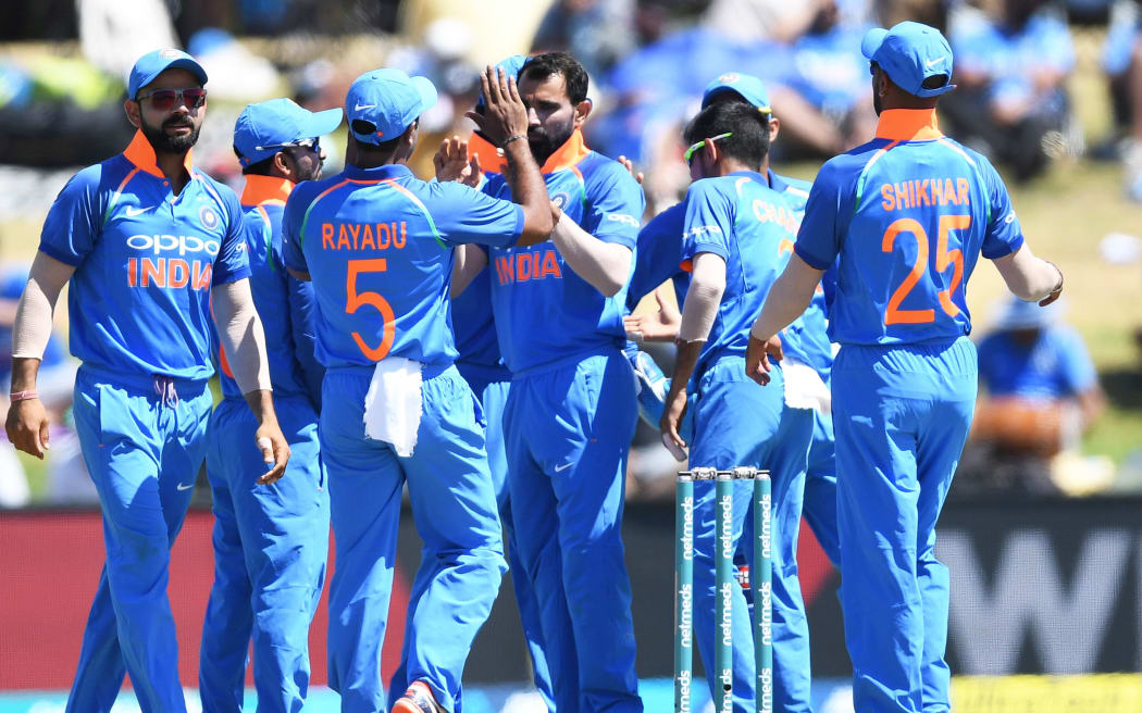 India players celebrate a Black Caps  wicket.