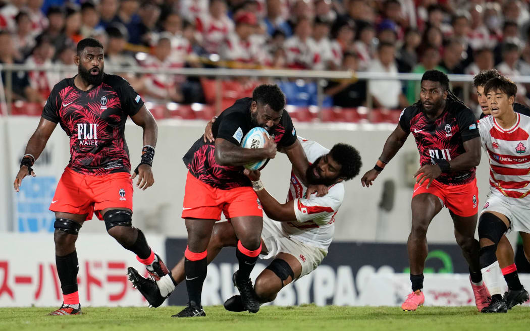HIGASHIOSAKA, JAPAN - SEPTEMBER 21: Samu Tawake of Fiji is tackled by Epineri Rev. Uluiviti of Japan during the World Rugby Pacific Nations Cup Final between Fiji and Japan at Hanazono Rugby Stadium on September 21, 2024 in Higashiosaka, Osaka, Japan. (Photo by Toru Hanai - World Rugby/World Rugby via Getty Images)