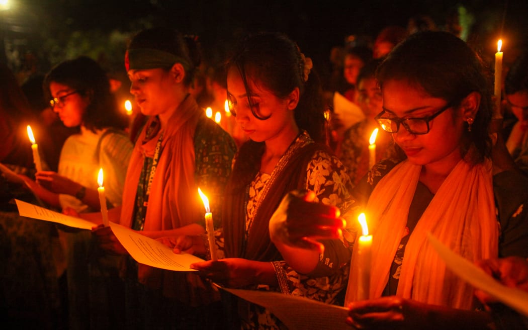 Bangladeshi women march through the streets of Dhaka on 16 August, 2024, during a candlelight vigil in a protest against rape in Dhaka, following the rape and murder of a doctor in Kolkata, India.