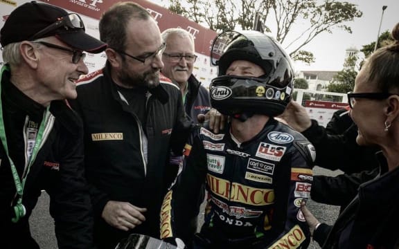Clive Padgett (left) and other members of the Padgett Racing team congratulate Bruce Anstey after his win.