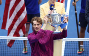 Italy's Jannik Sinner holds the trophy after winning his men's final match against USA's Taylor Fritz on day fourteen of the US Open tennis tournament at the USTA Billie Jean King National Tennis Center in New York City, on September 8, 2024. (Photo by CHARLY TRIBALLEAU / AFP)