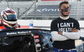 Nascar driver Bubba Wallace wears a "I Can't Breathe - Black Lives Matter" t-shirt.