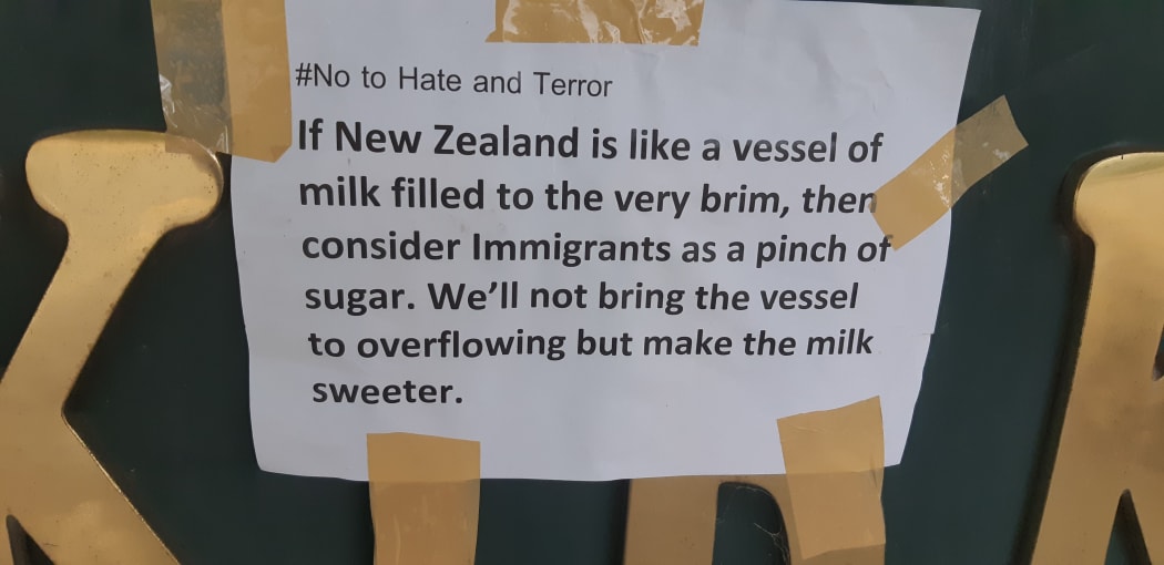 A message of unity with migrants among the tributes at Hagley Park.