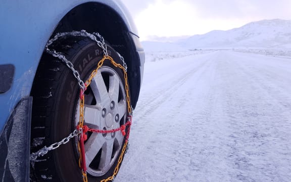 Snow in Tekapo, chains needed on road.