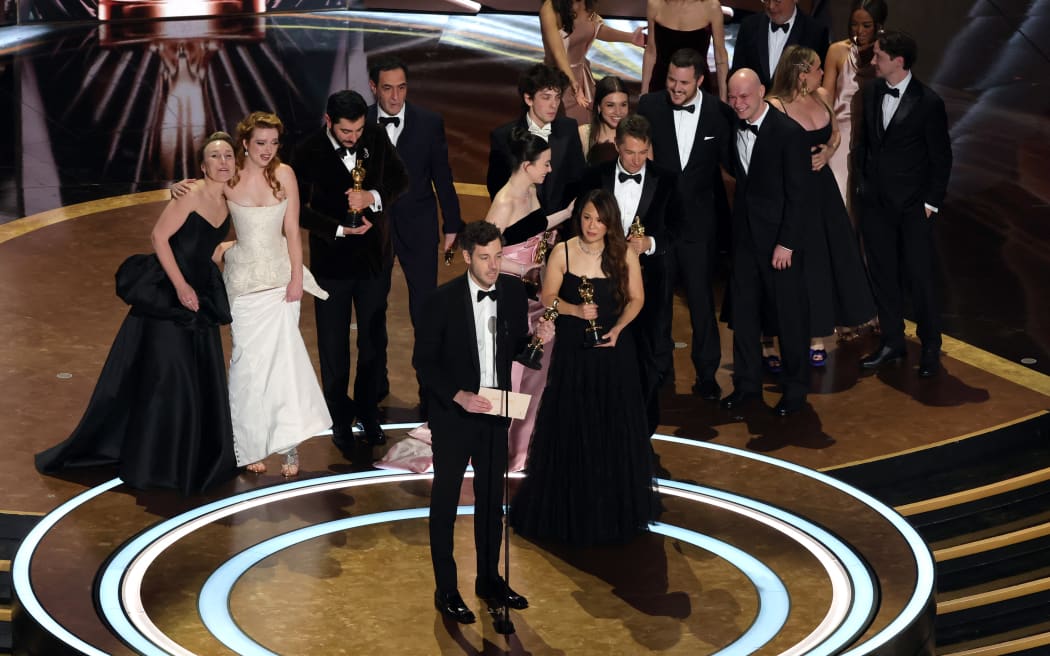 HOLLYWOOD, CALIFORNIA - MARCH 02: Cast and crew including Darya Ekamasova, Lindsey Normington, Vache Tovmasyan, Karren Karagulian, Alex Coco, Mikey Madison, Mark Eydelshteyn, Samantha Quan, Luna Sofía Miranda, Sean Baker, Drew Daniels and Yura Borisov accept the Best Picture award for "Anora" onstage during the 97th Annual Oscars at Dolby Theatre on March 02, 2025 in Hollywood, California.   Kevin Winter/Getty Images/AFP (Photo by KEVIN WINTER / GETTY IMAGES NORTH AMERICA / Getty Images via AFP)
