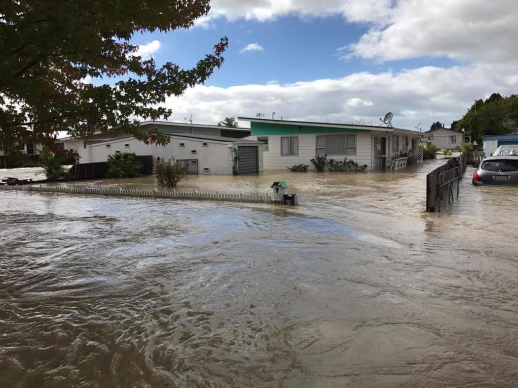 Floodwaters course through the streets of Edgecumbe