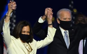 (FILES) In this file photo taken on November 7, 2020 US President-elect Joe Biden and Vice President-elect Kamala Harris stand onstage after delivering remarks in Wilmington, Delaware, after being declared the winners of the presidential election.