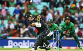 Martin Guptill hits a six.