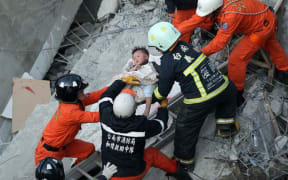 A child is rescued after a 6.4 quake in Taiwan.