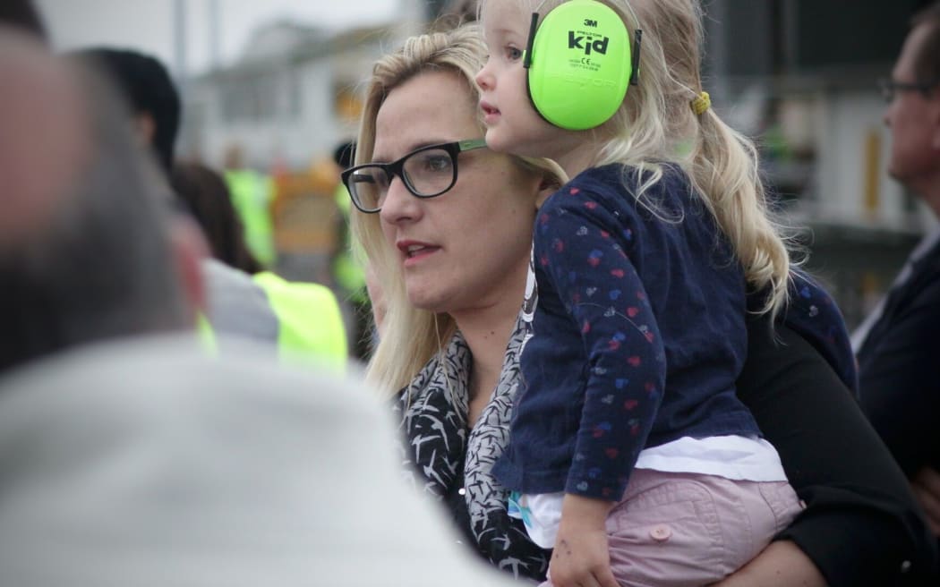 Jaime Peacock and her daughter wait for her husband to return.