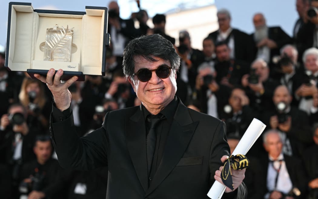 Iranian director and screenwriter and producer Jafar Panahi poses with the trophy during a photocall after winning the Palme d'Or for the film "Un simple accident" (A Simple Accident) during the closing ceremony at the 78th edition of the Cannes Film Festival in Cannes, southern France, on May 24, 2025. (Photo by Bertrand GUAY / AFP)