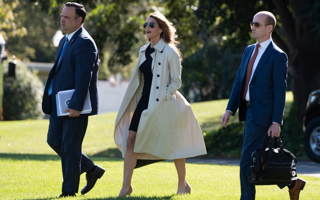 Dan Scavino (L), Director of White House Social Media, Hope Hicks, White House counselor, and Stephen Miller (R), White House senior advisor, walk to Marine One to join Trump, as he travels to Ohio.
