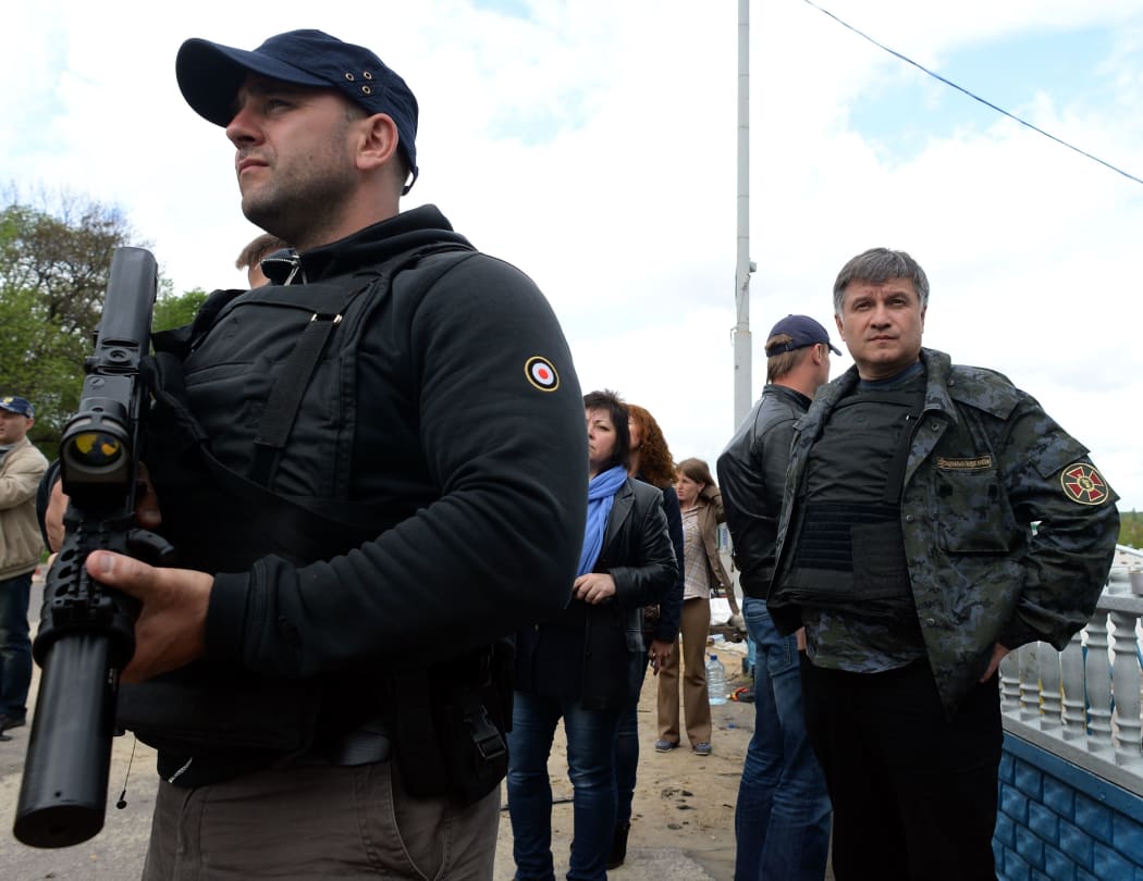 Ukrainian interior minister Arsen Avakov, right, looks on as he visits a checkpoint near the eastern Ukranian city of Slavyansk, May 2014.