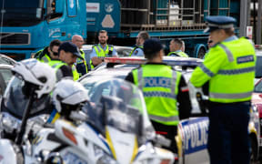 Police gather near the intersection of SH1 and Mill Rd, Bombay, prior to setting up a Covid-19 roadblock.