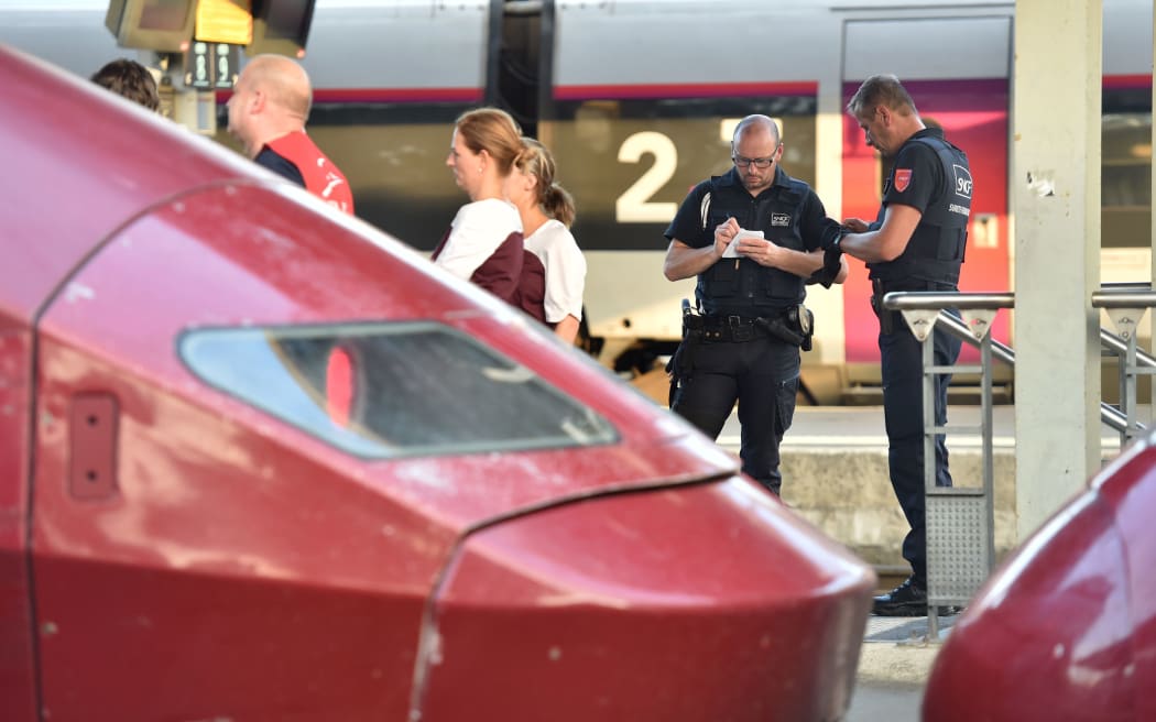 Train personnel stand next to Thalys trains at the main train station in Arras, northern France, following the shooting.