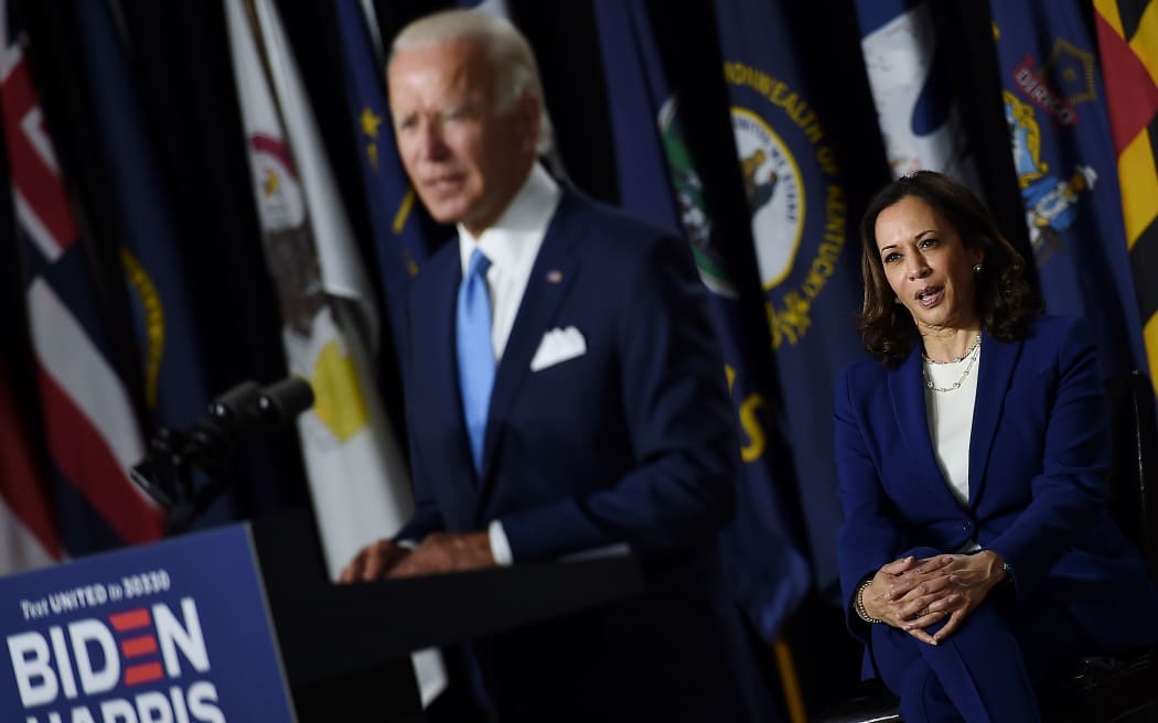 Democratic vice presidential running mate, US Senator Kamala Harris, listens to presidential nominee and former US Vice President Joe Biden speak during their first press conference together in Wilmington, Delaware, on August 12, 2020.