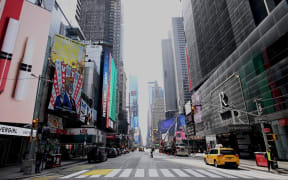An almost empty street is seen at Times Square in Manhattan on March 16, 2020 in New York City.