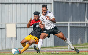 Fiji's Savenaca Baledrokadroka up against Papua New Guinea's Tyran Vapara