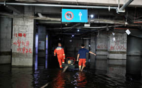 Rescue workers are conducting drainage operations in a store in Chongqing, China on 9 July, 2025.