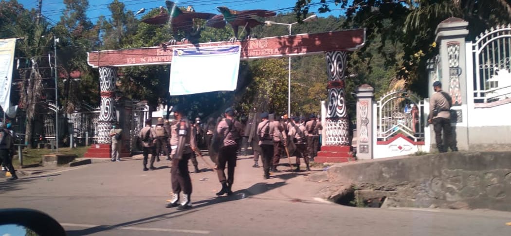 Police move in to stop a demonstration involving students from the University of Cenderawasih in Jayapura, 14 July, 2021.