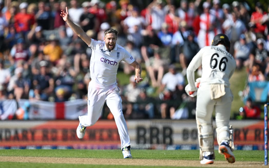 England bowler Chris Woakes runs down the wicket as he celebrates the dismissal of New Zealand batsman Tom Blundell during the first cricket test at Hagley Oval in Christchurch, Nov 30, 2024.