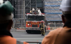 Firefighters gather around SkyCity convention centre where a fire has broken out.